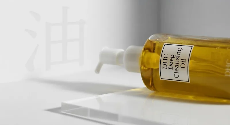 DHC Deep Cleansing Oil bottle on a white studio surface